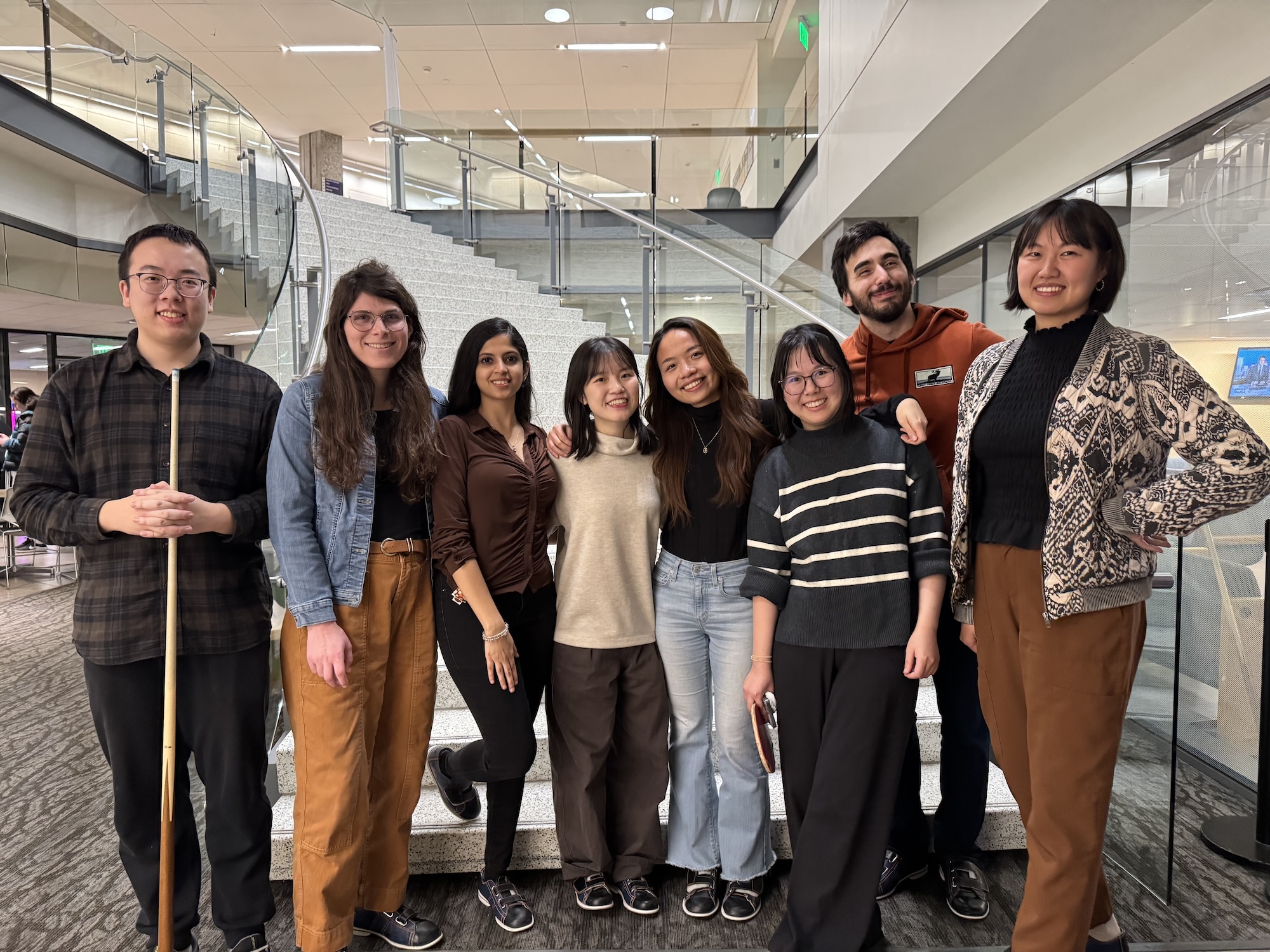 lab members standing in front of a staircase