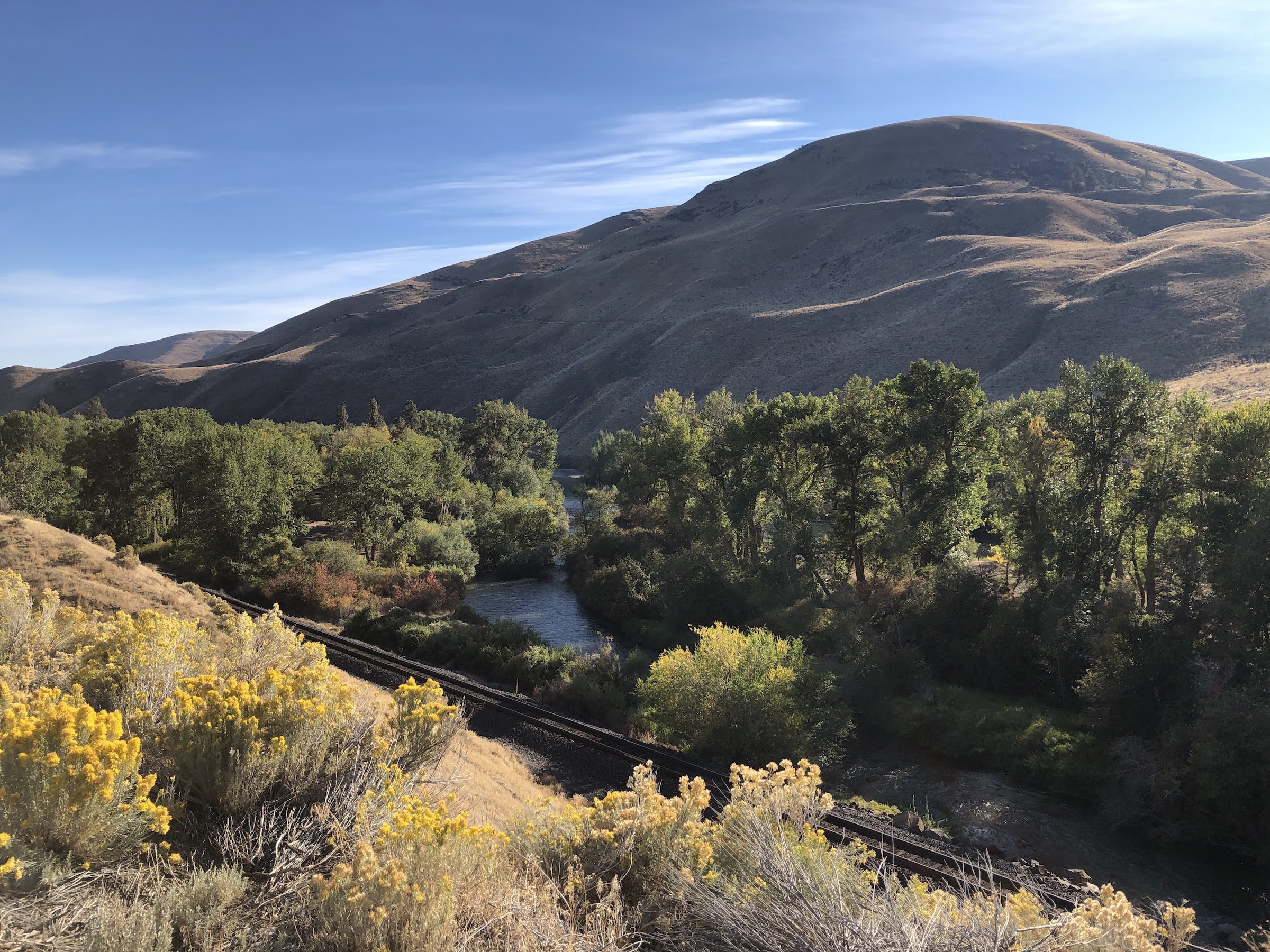 dry desert canyon with river and train trackd
