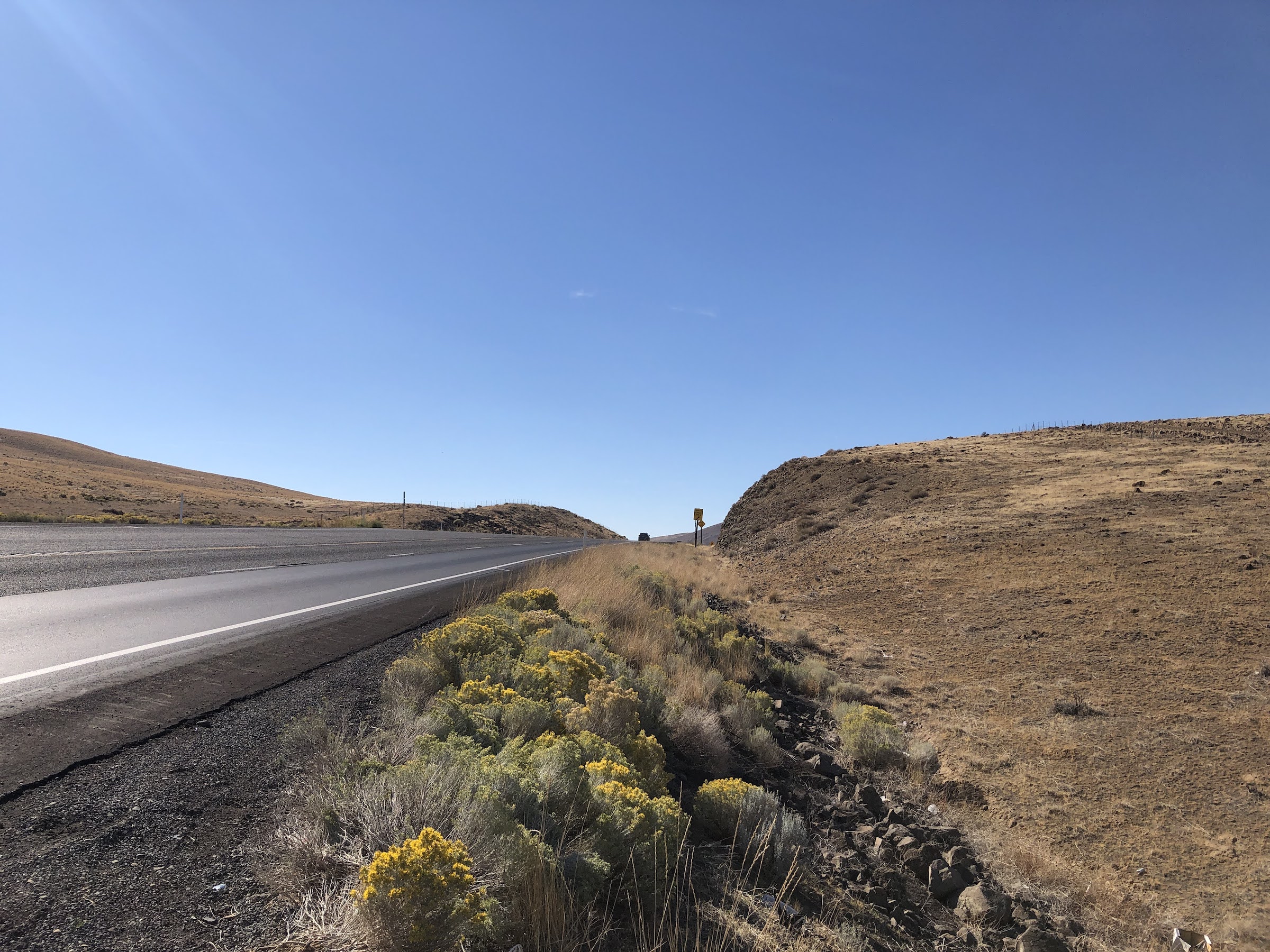 a highway stretches up towards a pass