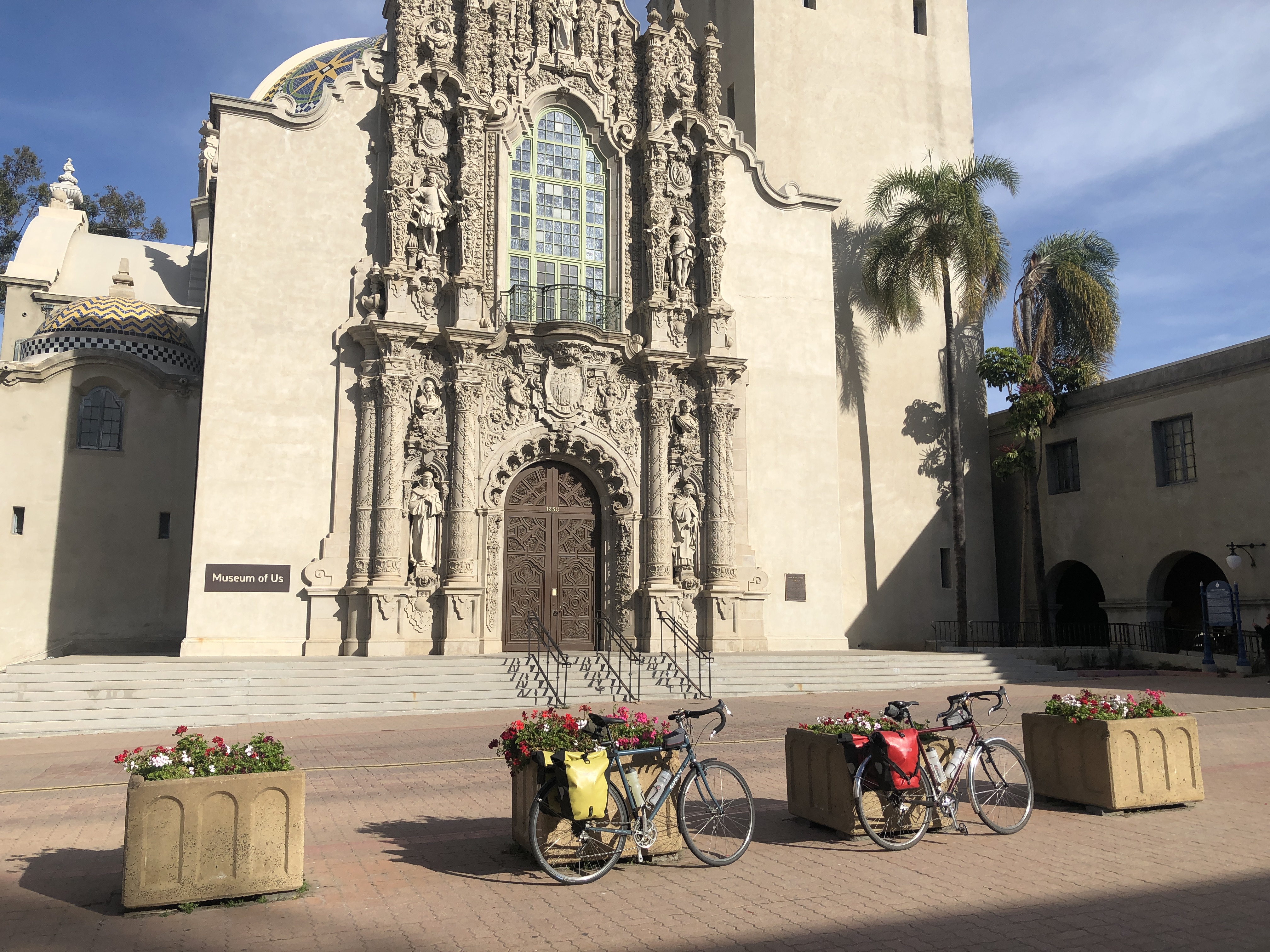 two bikes sitting in front of a museum in balboa park