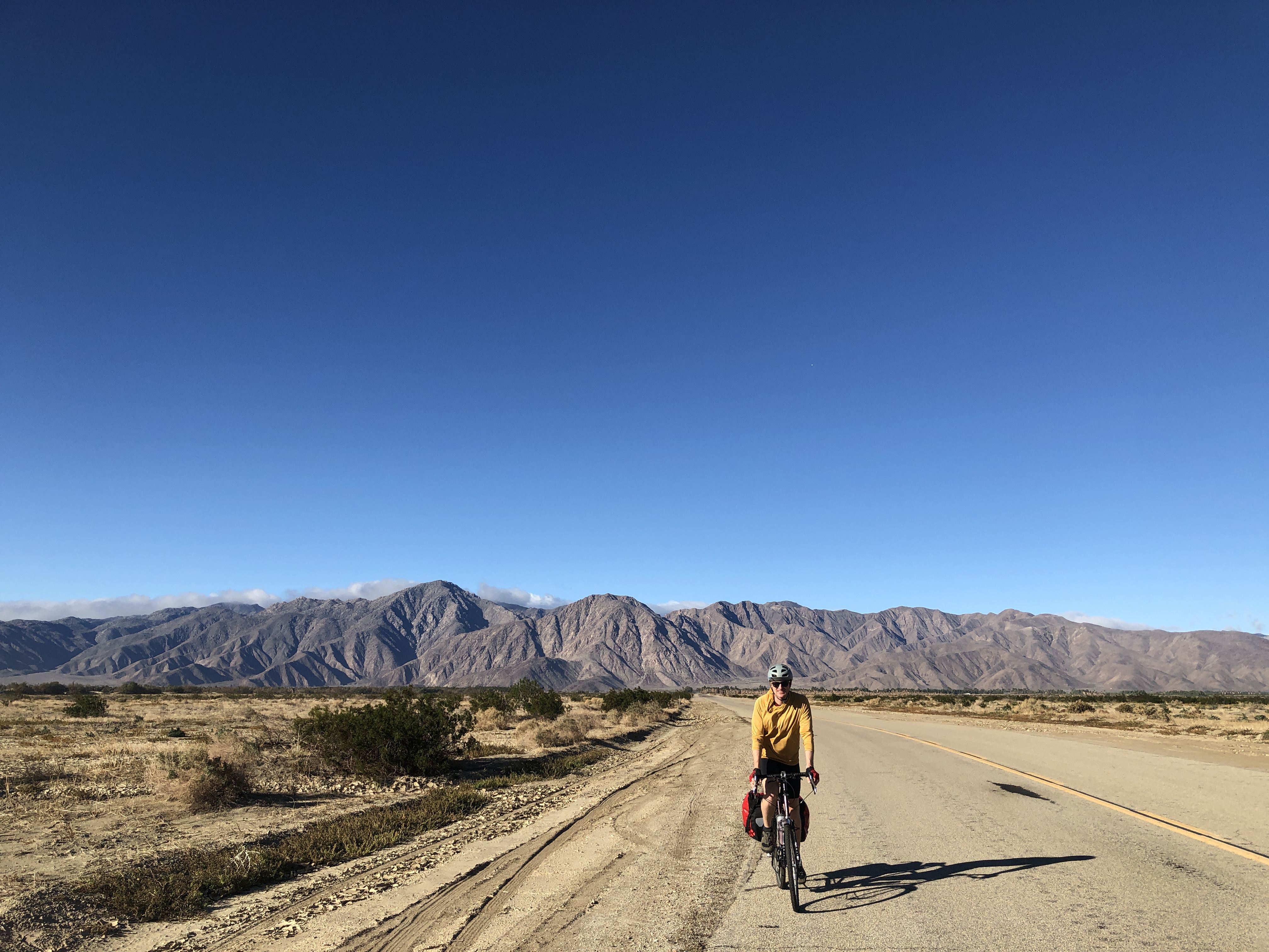 a man on a bike riding in the desert